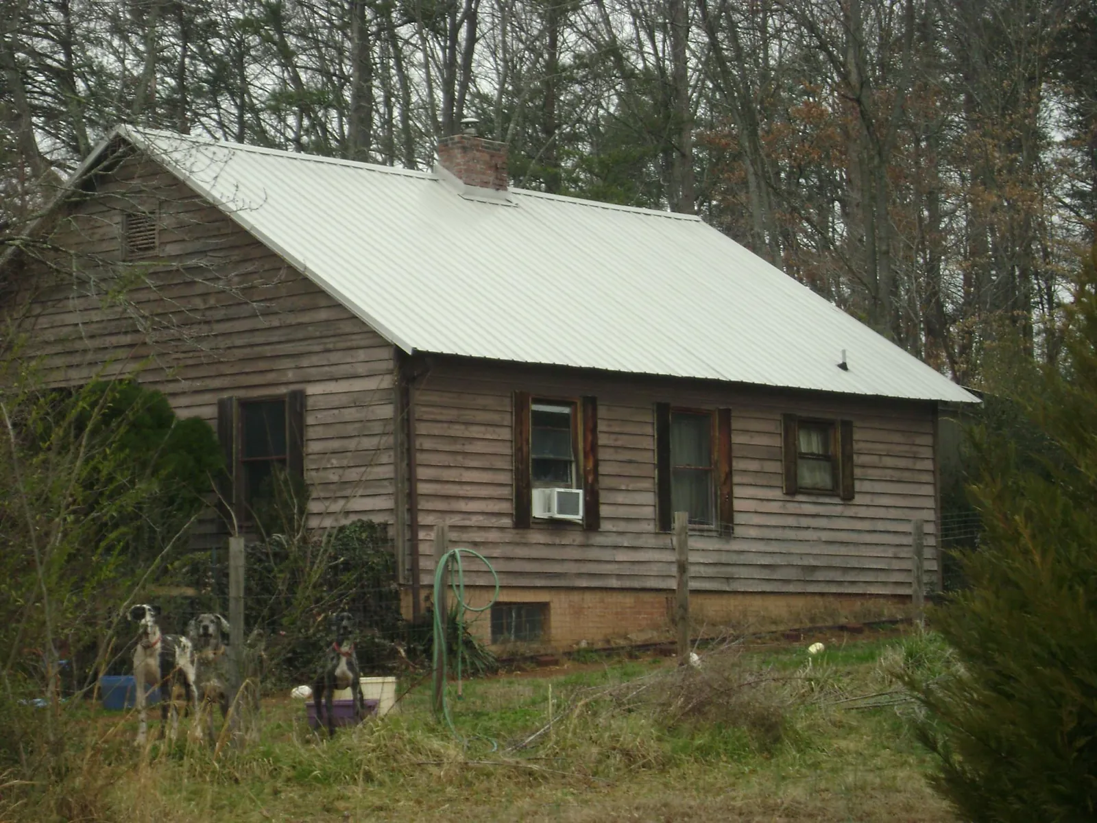 White metal roof on an old wood sided farmhouse, from a Metal Roof Installation job in Markleysburg